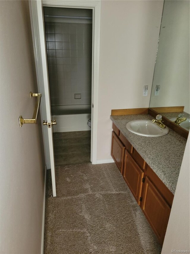 2619 S Iris Ct, Lakewood, CO 80227 - full bath featuring vanity, toilet, baseboards, and bathtub / shower combination