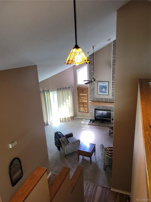 2619 S Iris Ct, Lakewood, CO 80227 - living room featuring ceiling fan, high vaulted ceiling, a fireplace, dark wood-style floors, and baseboards