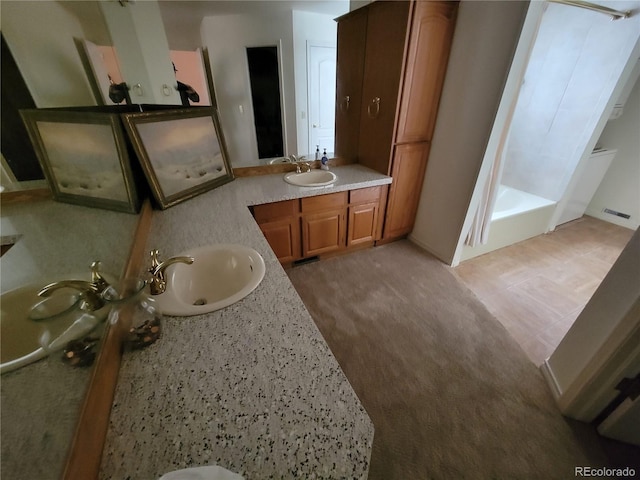 2619 S Iris Ct, Lakewood, CO 80227 - full bathroom featuring two vanities, a shower with shower curtain, a bath, and baseboards