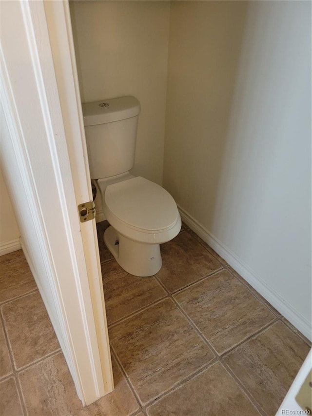 2619 S Iris Ct, Lakewood, CO 80227 - bathroom featuring tile patterned floors, toilet, and baseboards