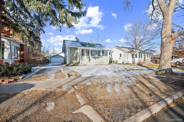 view of front of home with a garage and an outdoor structure