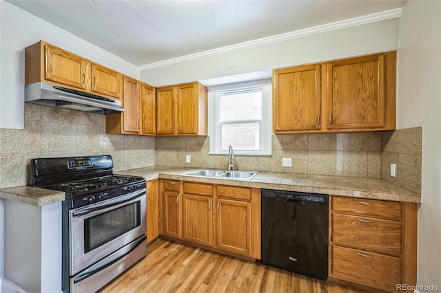 kitchen featuring stainless steel range with gas cooktop, sink, light wood-type flooring, black dishwasher, and ornamental molding