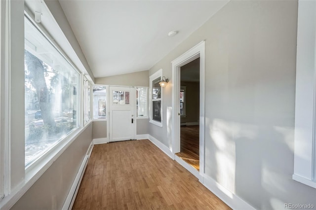 hall with light hardwood / wood-style floors and lofted ceiling