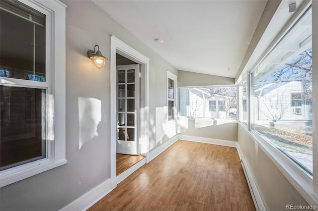 sunroom with vaulted ceiling and baseboard heating