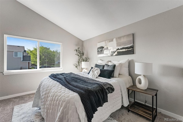 carpeted bedroom with vaulted ceiling, a textured wall, and baseboards