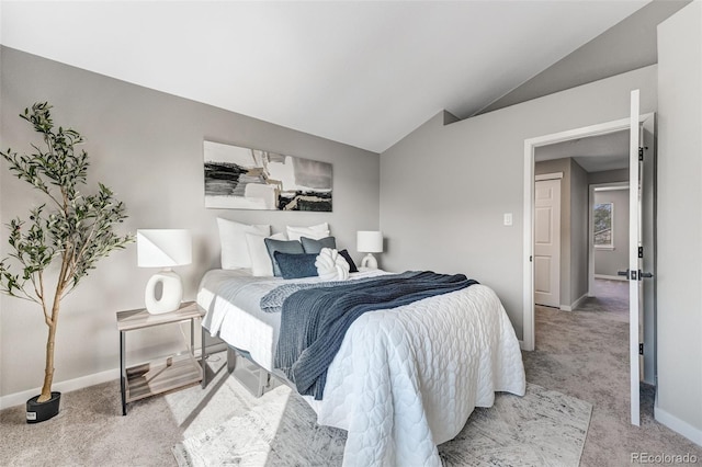 bedroom featuring baseboards, light carpet, and vaulted ceiling