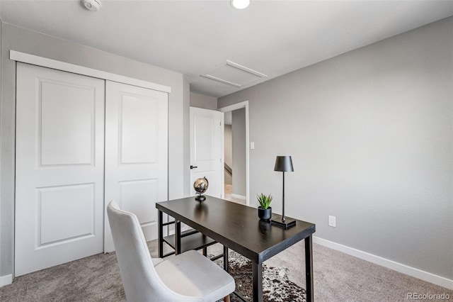 carpeted office space featuring attic access and baseboards
