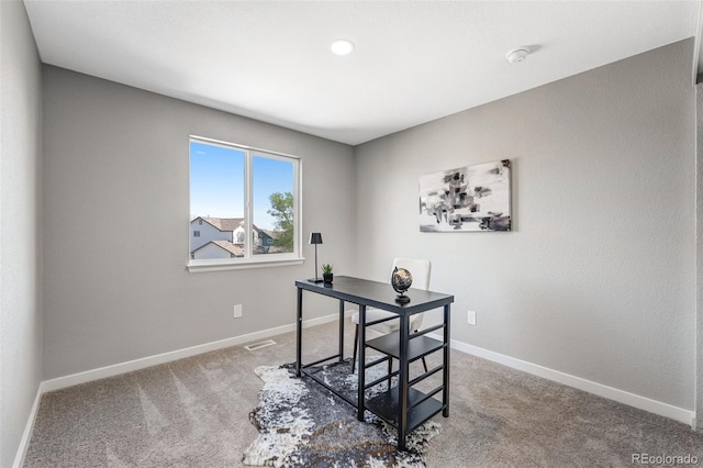 office area featuring carpet flooring, visible vents, and baseboards
