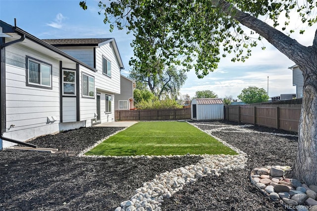 view of yard featuring a fenced backyard, a storage shed, and an outdoor structure