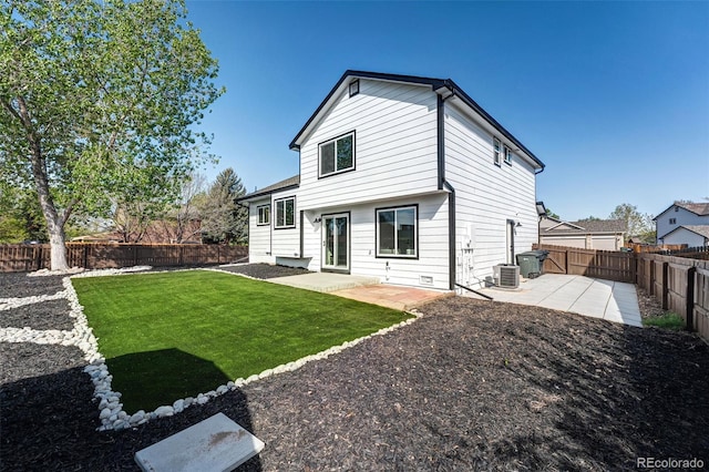 rear view of house featuring a lawn, a patio, and a fenced backyard