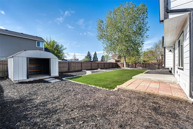 view of yard featuring a fenced backyard, a patio, and a shed