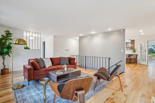 living area with light wood-type flooring and recessed lighting
