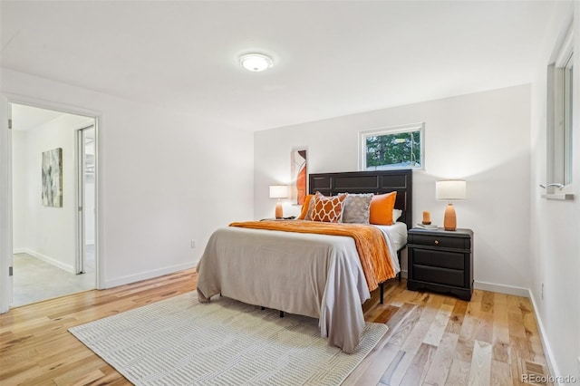 bedroom featuring wood finished floors and baseboards