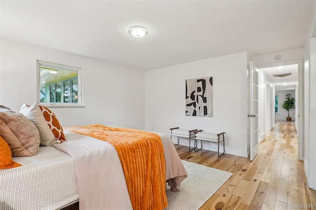bedroom with light wood-style flooring and baseboards
