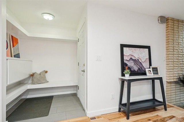 hall with baseboards and wood finished floors