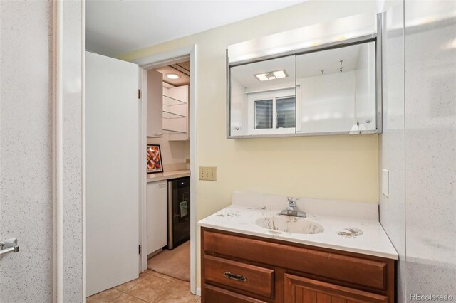 bathroom featuring vanity, tile patterned flooring, and beverage cooler