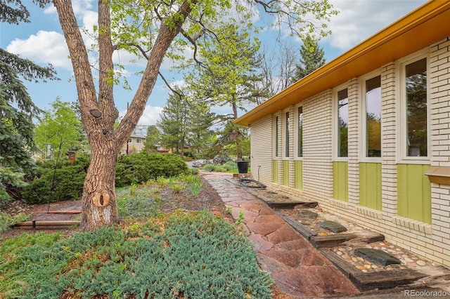 view of side of property featuring brick siding
