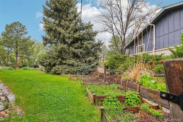 view of grassy yard with a garden