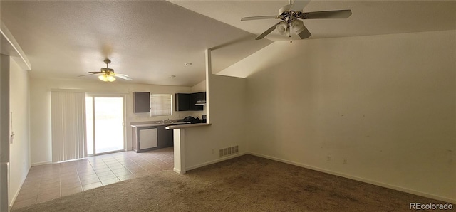 unfurnished living room with lofted ceiling, ceiling fan, light colored carpet, and a textured ceiling