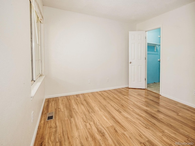 13894 E Lehigh Ave Unit G, Aurora, CO 80014 - unfurnished room with wood finished floors and baseboards