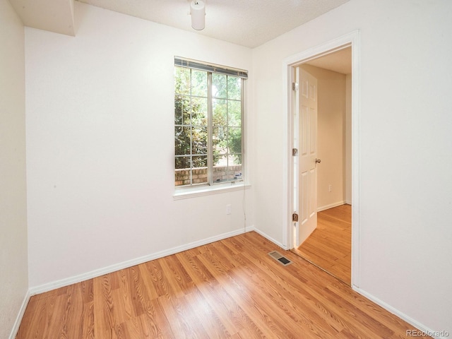 13894 E Lehigh Ave Unit G, Aurora, CO 80014 - spare room with light wood finished floors and baseboards