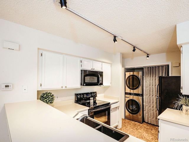 13894 E Lehigh Ave Unit G, Aurora, CO 80014 - kitchen featuring black appliances, estacked washer and dryer, rail lighting, a textured ceiling, and white cabinets