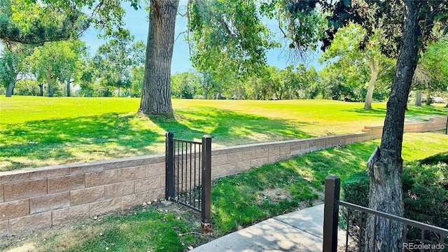 13894 E Lehigh Ave Unit G, Aurora, CO 80014 - view of property's community with a gate and view of wooded area