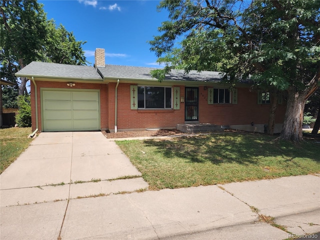 6525 E Harvard Ave, Denver, CO 80224 - single story home featuring concrete driveway, an attached garage, a chimney, a front yard, and brick siding