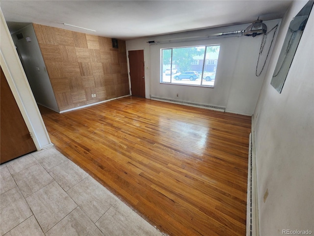 6525 E Harvard Ave, Denver, CO 80224 - empty room featuring a baseboard radiator and wood finished floors