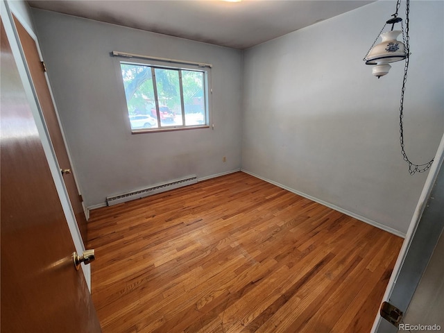 6525 E Harvard Ave, Denver, CO 80224 - empty room with a baseboard radiator and light wood-style floors