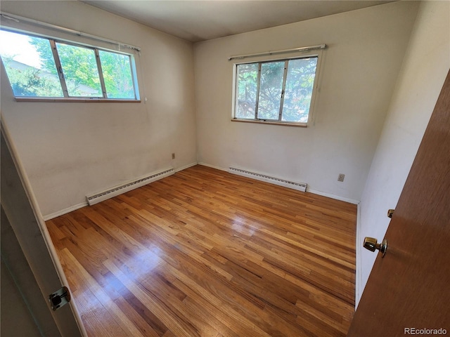 6525 E Harvard Ave, Denver, CO 80224 - unfurnished room featuring a baseboard radiator and wood finished floors