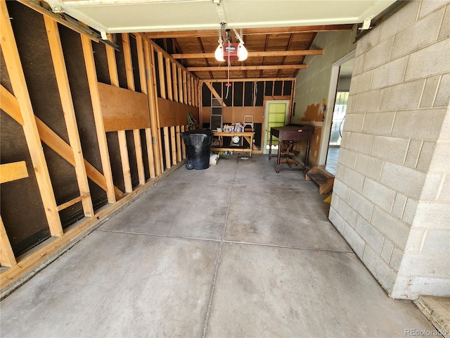 6525 E Harvard Ave, Denver, CO 80224 - garage with a garage door opener and concrete block wall