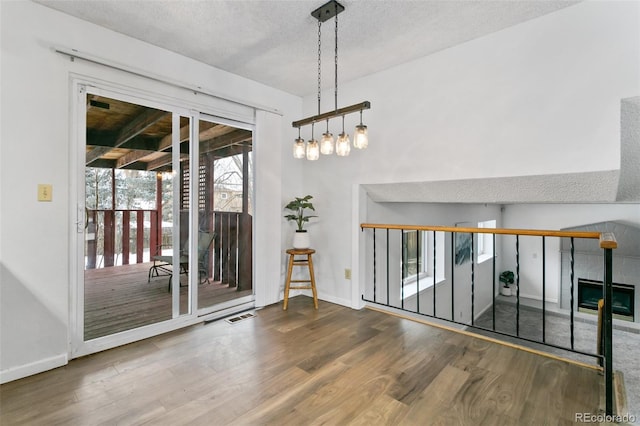 unfurnished room with wood-type flooring and a textured ceiling