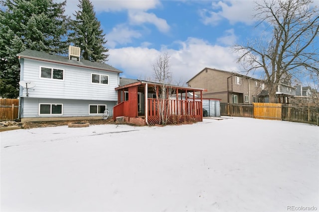 view of snow covered rear of property