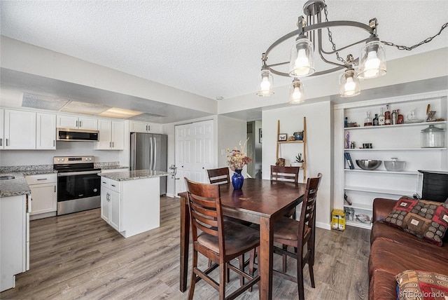 8666 Mariposa St, Thornton, CO 80260 - dining space with a textured ceiling and wood finished floors