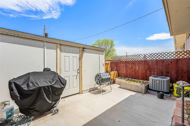 8666 Mariposa St, Thornton, CO 80260 - view of patio with fence, an outdoor structure, grilling area, central AC unit, and a storage unit