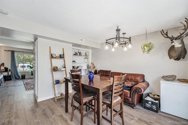 8666 Mariposa St, Thornton, CO 80260 - dining space with visible vents, a textured ceiling, and wood finished floors