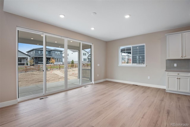 unfurnished living room featuring light hardwood / wood-style flooring