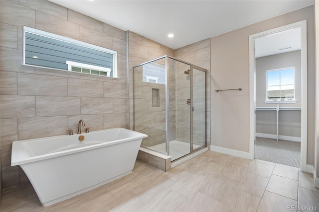 bathroom with tile patterned floors and independent shower and bath