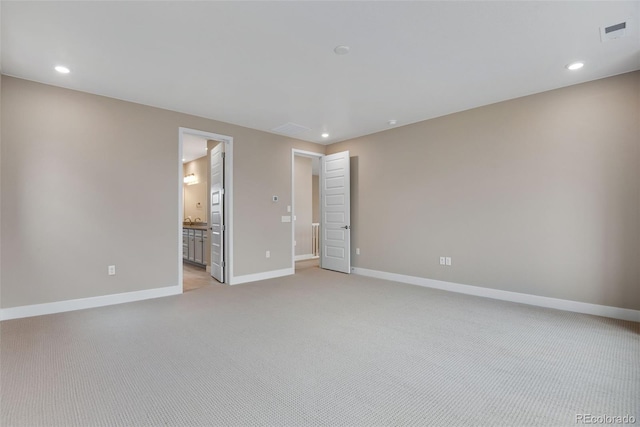 spare room with light colored carpet