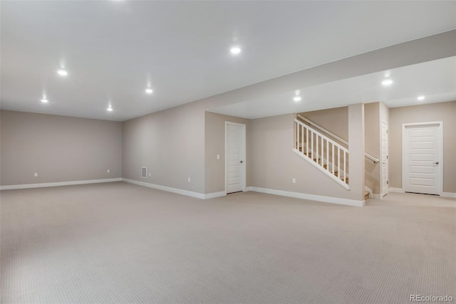 basement featuring light carpet