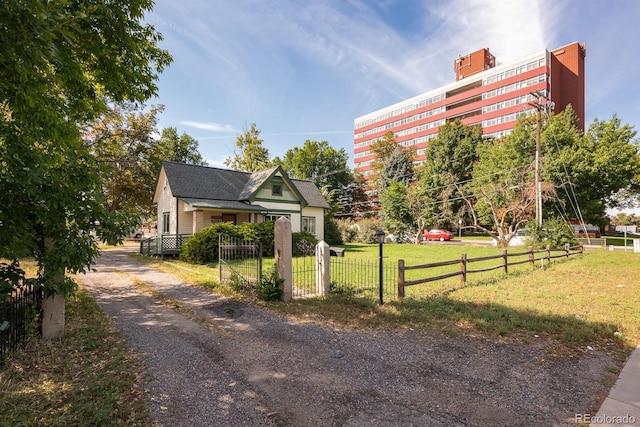 view of home's community featuring a fenced front yard and a lawn