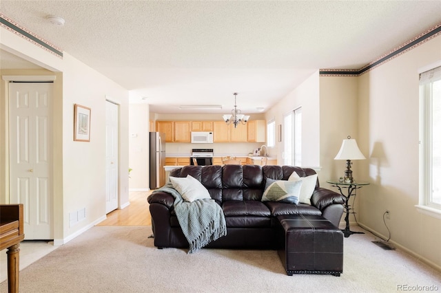 21105 Willow Park Pl, Parker, CO 80138 - living area featuring a chandelier, light carpet, and healthy amount of natural light