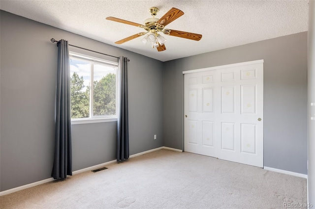21105 Willow Park Pl, Parker, CO 80138 - unfurnished bedroom with light carpet, a closet, a textured ceiling, and a ceiling fan