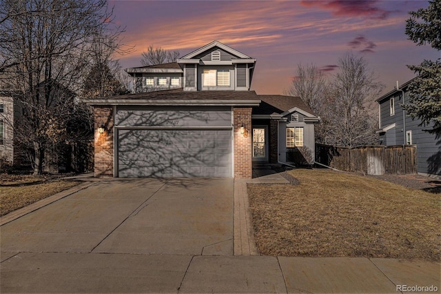 view of front of house featuring a garage and a lawn