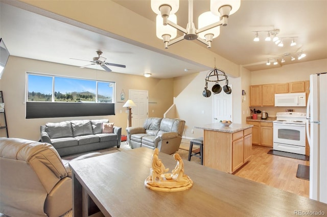 kitchen with light hardwood / wood-style floors, white appliances, light brown cabinets, and a kitchen island