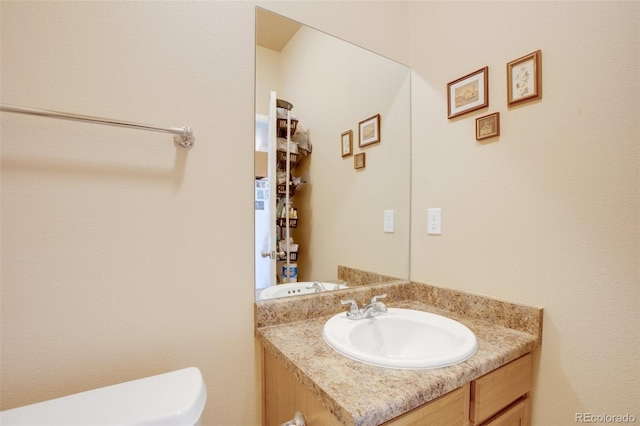 bathroom with toilet and vanity