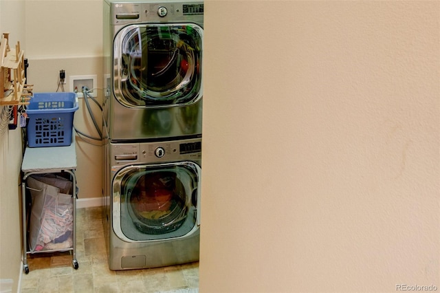 laundry room featuring stacked washer / drying machine