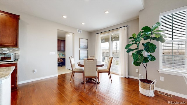 dining space featuring hardwood / wood-style floors and a wealth of natural light