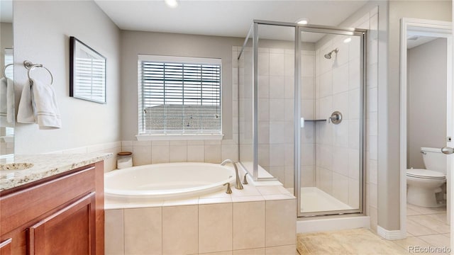 full bathroom featuring vanity, tile patterned floors, separate shower and tub, and toilet